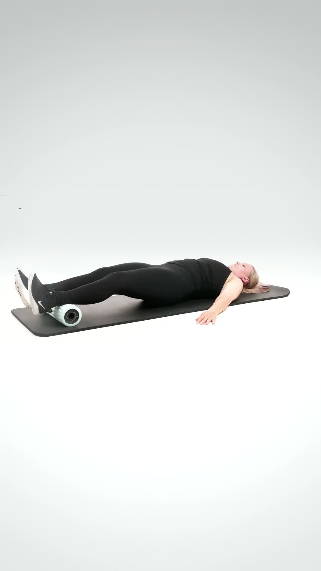 Foam Roller Hamstring Curl exercise stock photo, hamstrings