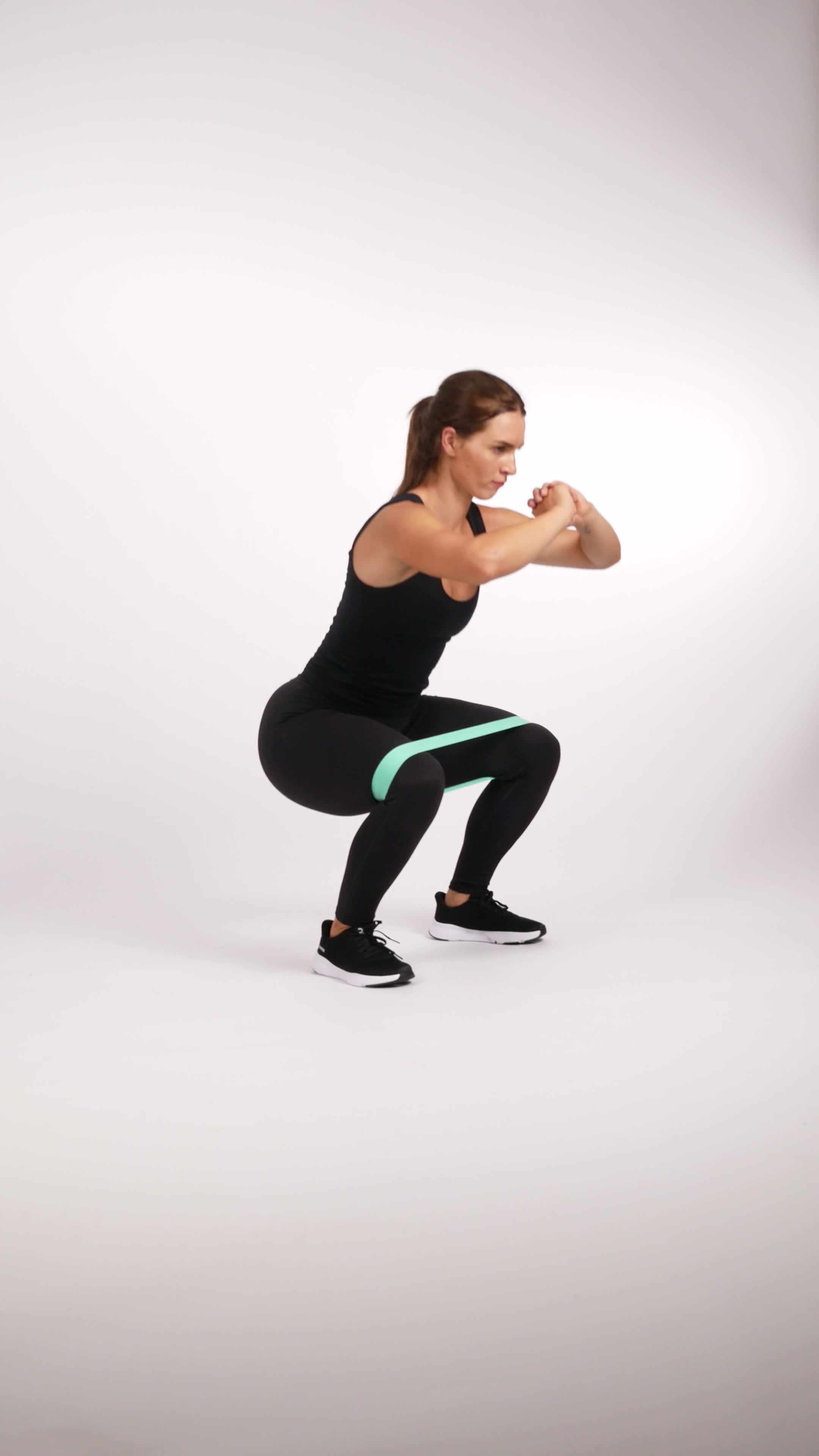 Banded squat exercise stock photo, quads