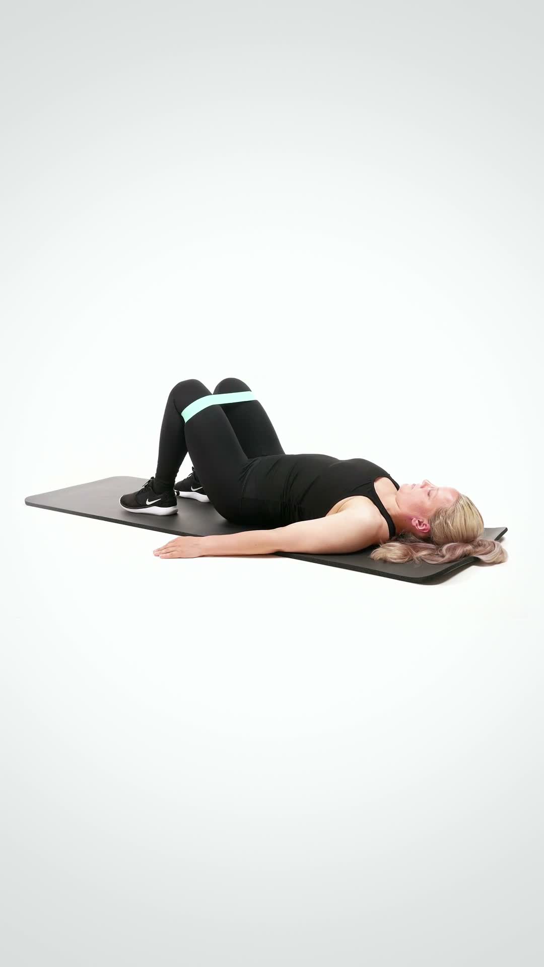 Banded Glute Bridge exercise stock photo, glutes