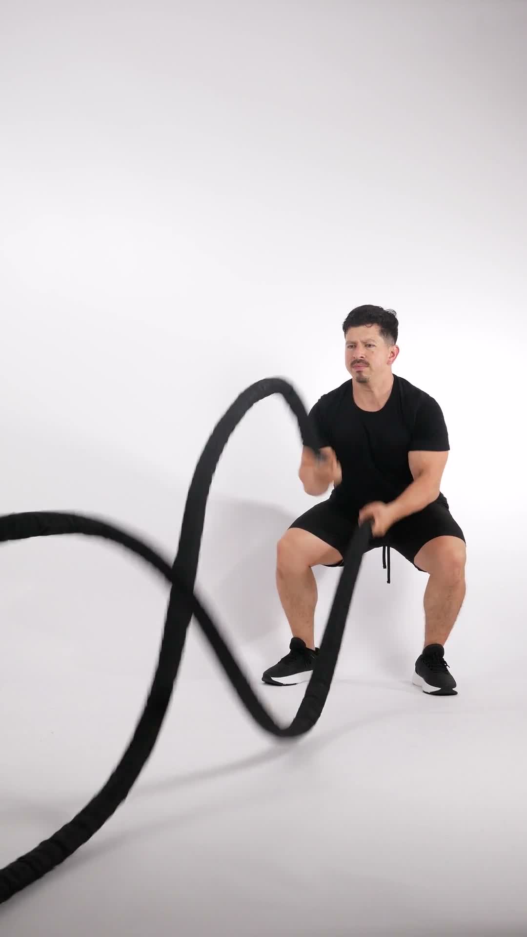 Battle Rope Squat Hold Waves exercise stock photo, full body